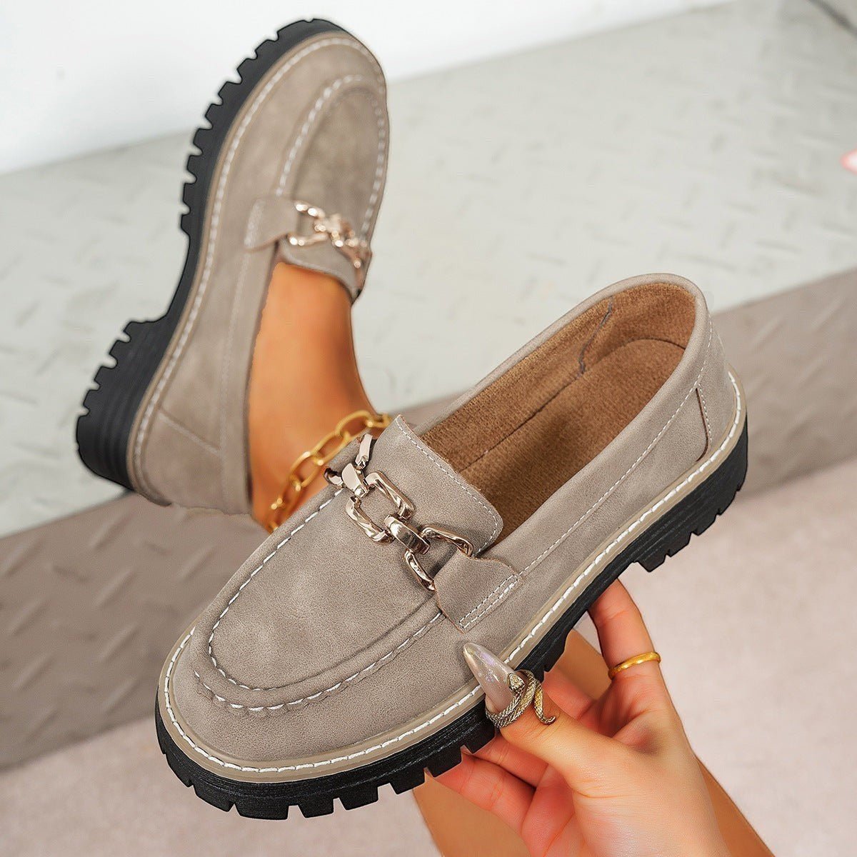 ZOFIA ATELIER taupe suede chunky platform loafers with gold chain detail and white stitching.