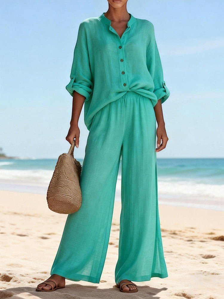 ZOFIA ATELIER teal cotton lounge set with V-neck long sleeve top and wide-leg pants on a beach.