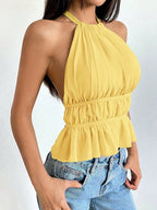 ZOFIA ATELIER URSZULA yellow pleated halter top made of polyester with a ruffled hem and backless design.