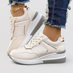 ZOFIA ATELIER creamy-white PU wedge sneakers with microfiber lining and round toe. Lace-up closure.