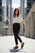 ZOFIA ATELIER WERONIKA leopard print flat shoes with round toe, worn by a woman in black pants and white blouse.
