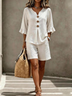 ZOFIA ATELIER white bamboo cotton buttoned v-neck set with flared sleeves and shorts.