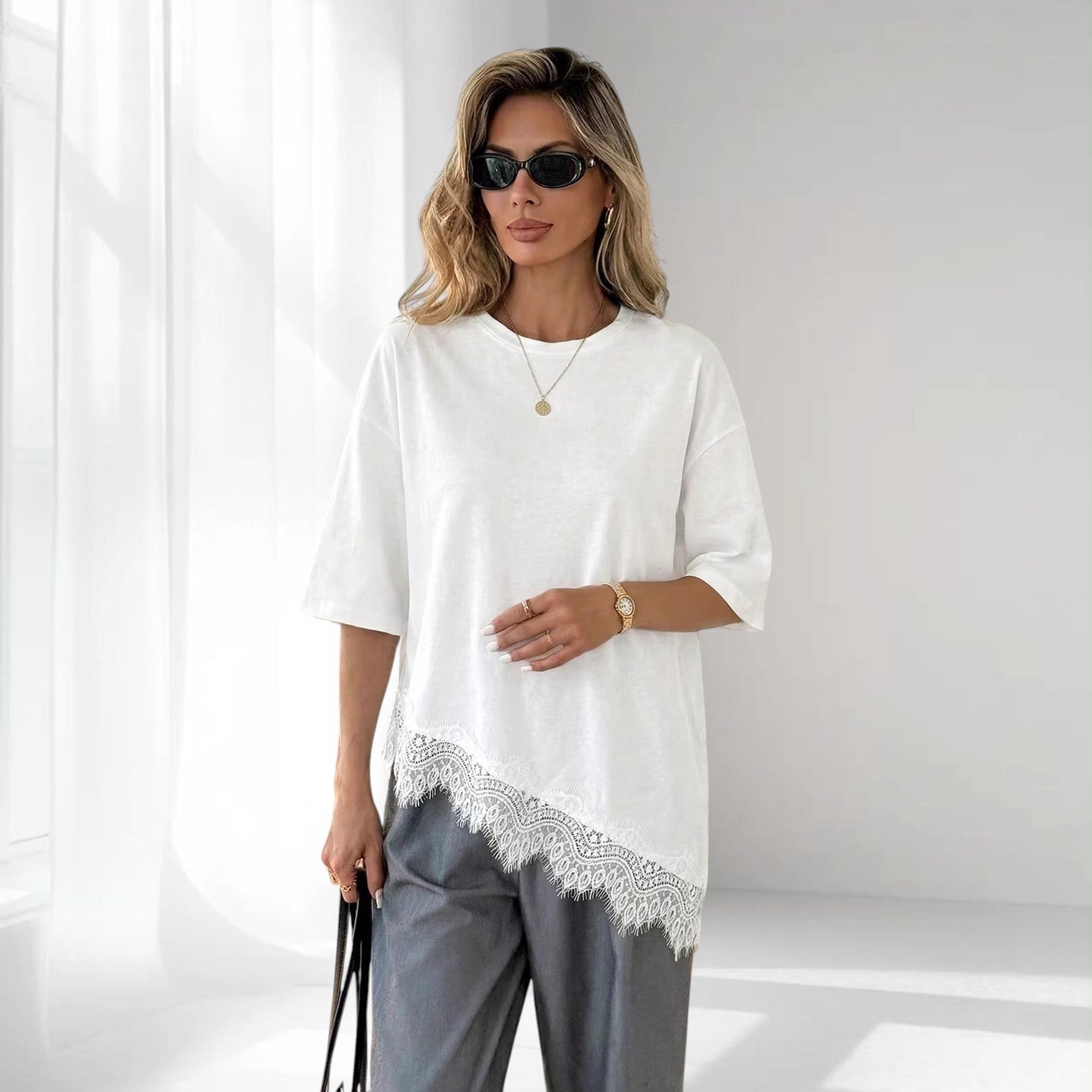 ZOFIA ATELIER white cotton loose fit short sleeve top with a delicate lace-panel hem.