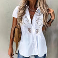 ZOFIA ATELIER white short-sleeved rayon and polyester blouse with embroidered lace detail.