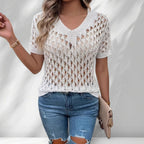ZOFIA ATELIER white knitted V-neck short sleeve top with hollow-out details, paired with distressed jeans.