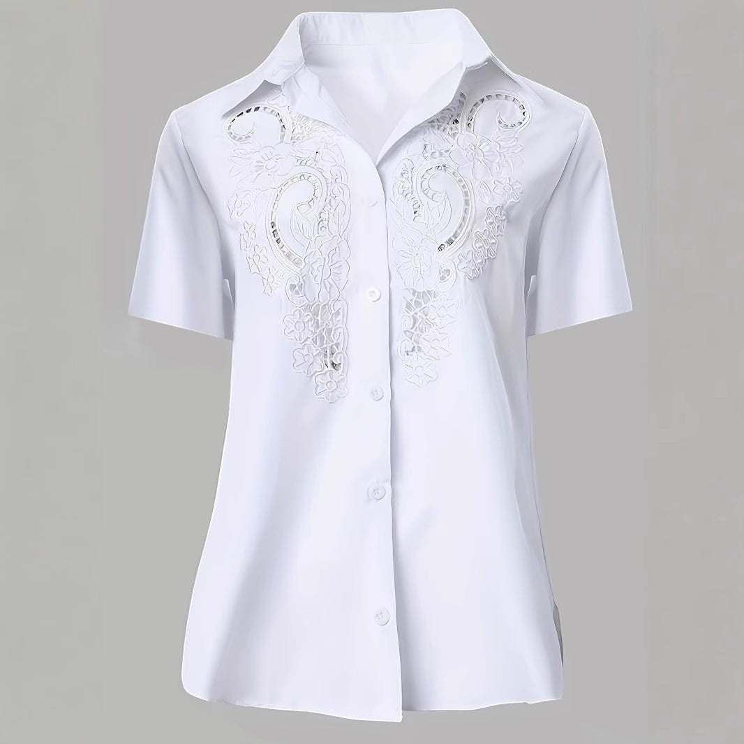 ZOFIA ATELIER white short-sleeved blouse with intricate embroidered lace detail and hollow-out design. Made from polyester and rayon.