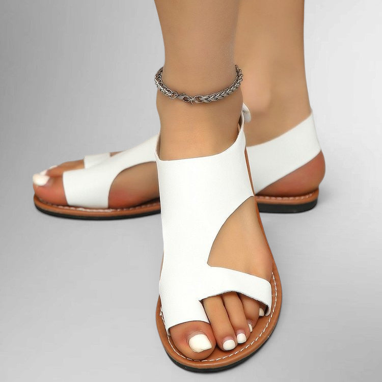 ZOFIA ATELIER white leather flat sandals with velcro toe strap and open heel. Comfortable everyday footwear.