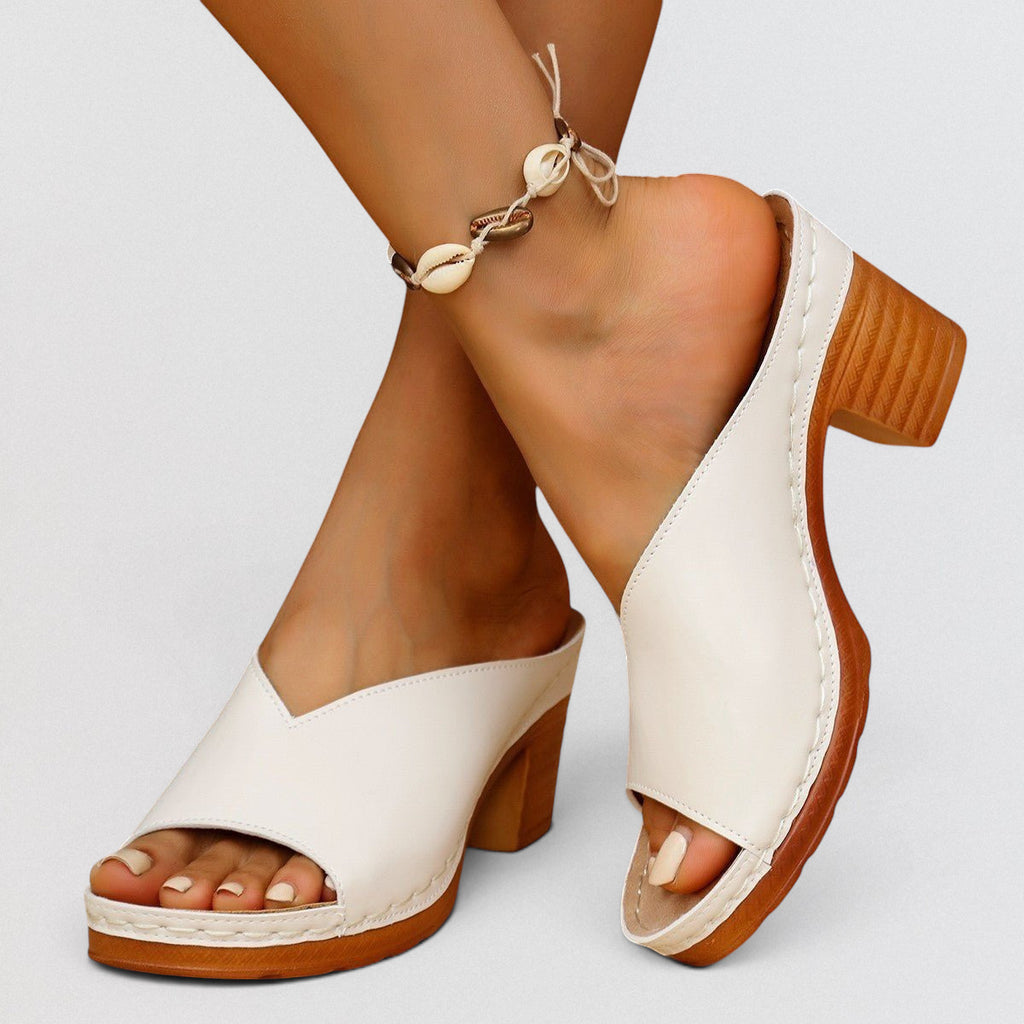 ZOFIA ATELIER white leather square-toe block heel mule slippers with a wooden-look heel and platform.