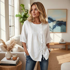 ZOFIA ATELIER white linen asymmetric shirt with lace-up detail and princess sleeves.