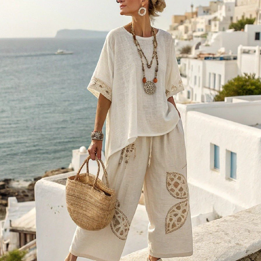 ZOFIA ATELIER white linen blend set with wide-leg cropped pants and flowing top, featuring crochet trim and embroidered details.