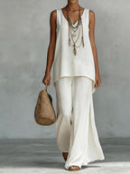 ZOFIA ATELIER white linen V-neck sleeveless vest and wide-leg pants set with layered necklace.