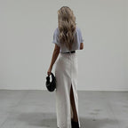 ZOFIA ATELIER white high-waist A-line maxi skirt with a back slit, made of spandex.