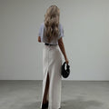 ZOFIA ATELIER white high-waist A-line maxi skirt with a back slit, made of spandex.