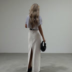 ZOFIA ATELIER white high-waist A-line maxi skirt with a back slit, made of spandex.