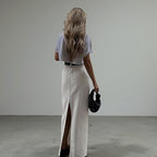 ZOFIA ATELIER white high-waist A-line maxi skirt with a back slit, made of spandex.