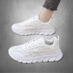 ZOFIA ATELIER white mesh casual running sneakers with lace-up closure and flat rubber sole.