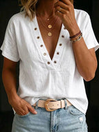 ZOFIA ATELIER white ramie V-neck blouse with grommet details and short sleeves, paired with denim.