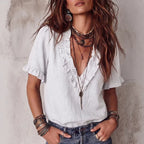 ZOFIA ATELIER white V-neck ruffled short sleeve polyester shirt with loose fit and delicate ruffles.