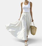 ZOFIA ATELIER white ankle-length skirt with blue pinstripes, button front, and pocket details.