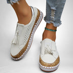 ZOFIA ATELIER white artificial PU tassel round toe flats with perforated details and cork-like sole trim.