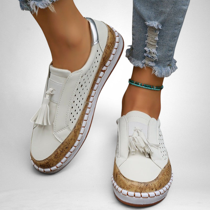 ZOFIA ATELIER white artificial PU tassel round toe flats with perforated details and cork-like sole trim.