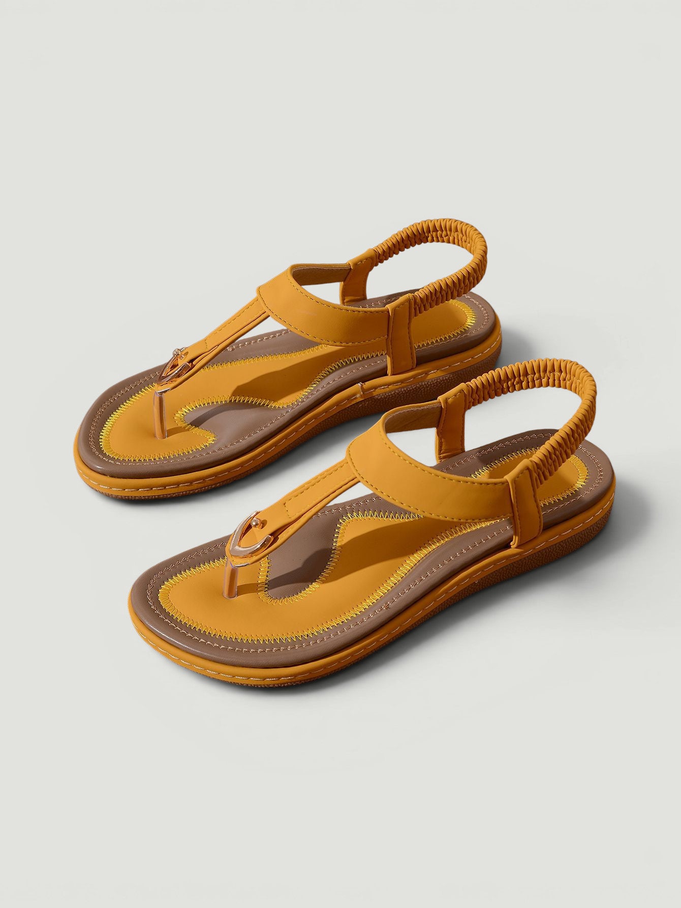 ZOFIA ATELIER Kasia yellow and brown PU flip-flops with elastic ankle strap and round toe.