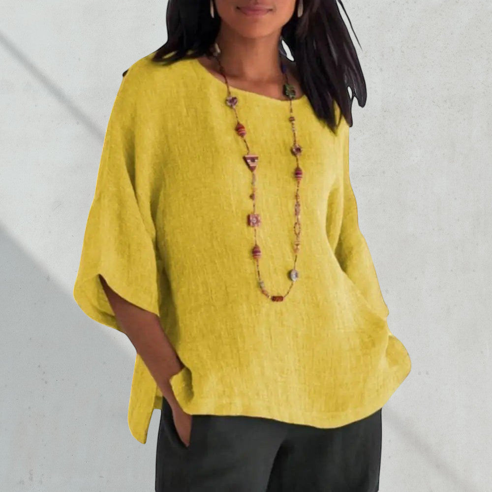 ZOFIA ATELIER yellow linen blend blouse with crew neck and short sleeves, featuring a relaxed fit and side slits.
